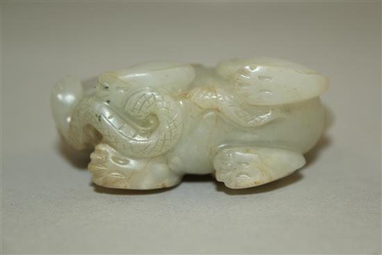 A Chinese pale celadon jade group of a lion-dog and a snake, 6.3cm